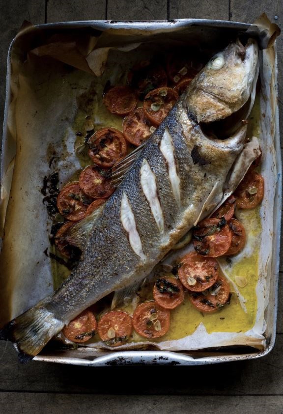 Baked sea bream or sea bass with tomatoes