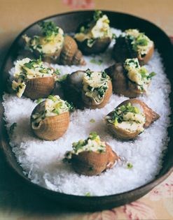 Baked sea snails with garlic shoots