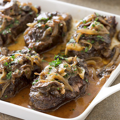 Baked steak with onions and mushrooms