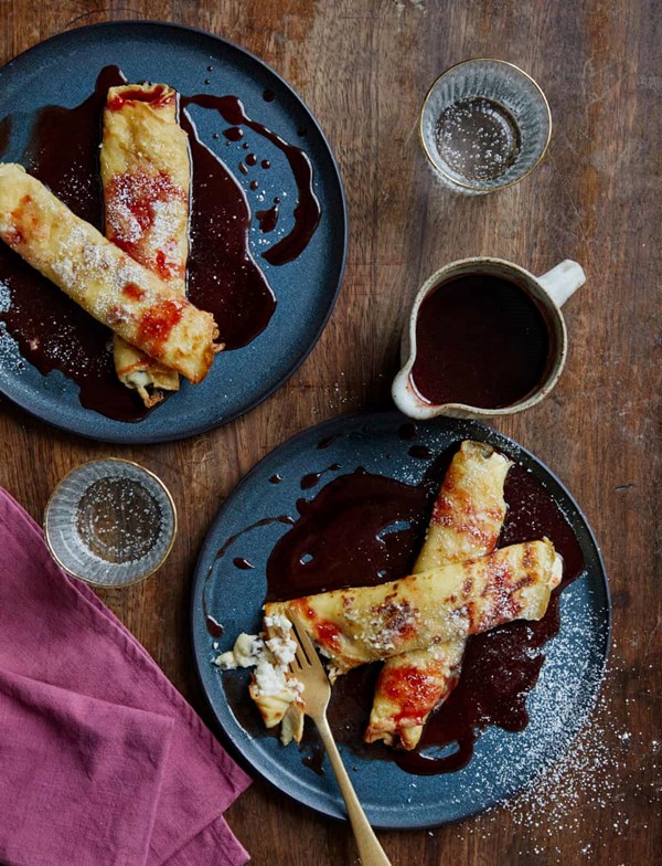 Baked stuffed pancakes with sour cherry sauce