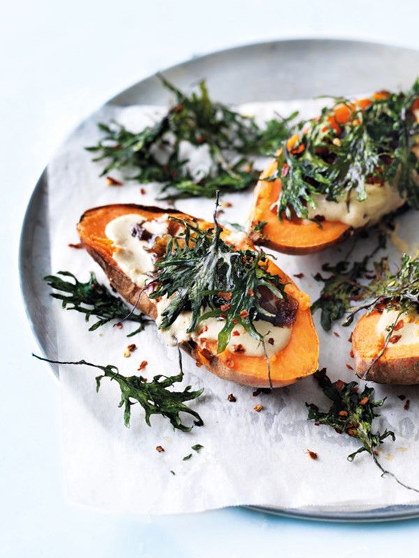 Baked sweet potatoes with hummus and kale