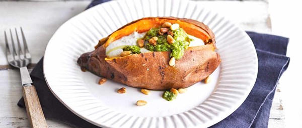Baked sweet potatoes with pine nuts, tahini and pesto