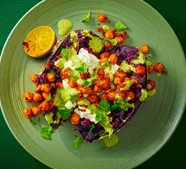 Baked sweet potatoes with whipped feta, spiced chickpeas & green tahini