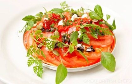 Baked tomato galette with goat's cheese, tapenade and pumpkin seeds