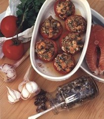 Baked tomatoes stuffed with salmon, garlic and capers