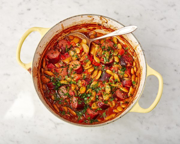 Baked white beans and sausages with paprika, onions and sweet peppers