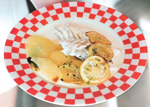 Baked whole fish with potatoes and lemons