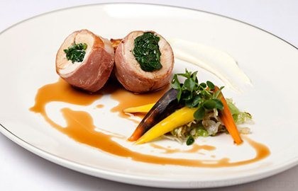 Ballotine of turkey with spinach, braised baby gems, potato rosti and thyme jus
