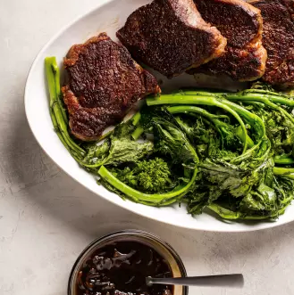 Balsamic-glazed strip steaks with roasted broccoli rabe