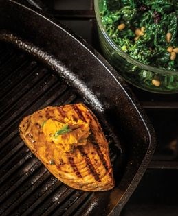 Balsamic-glazed swordfish with harissa herb butter over coconut kale