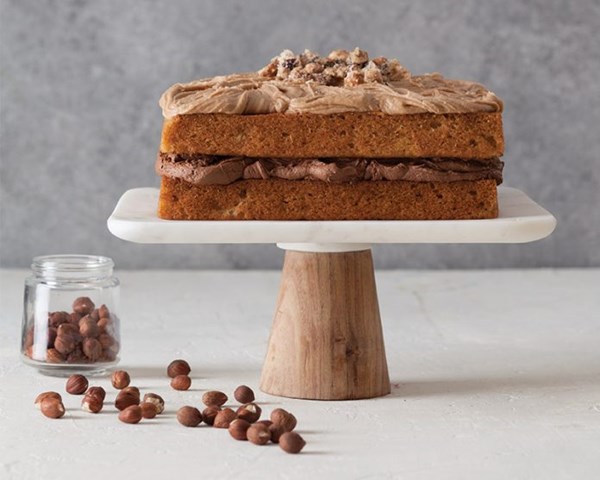Banana cake with brown sugar hazelnut buttercream [chocolate-hazelnut filling, praline hazelnuts]