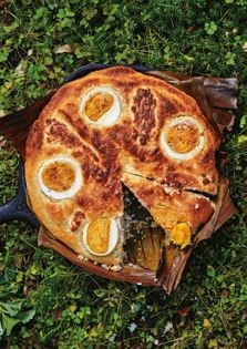 Banana leaf-roasted rice cake with salted egg and cheese (Bibingka)