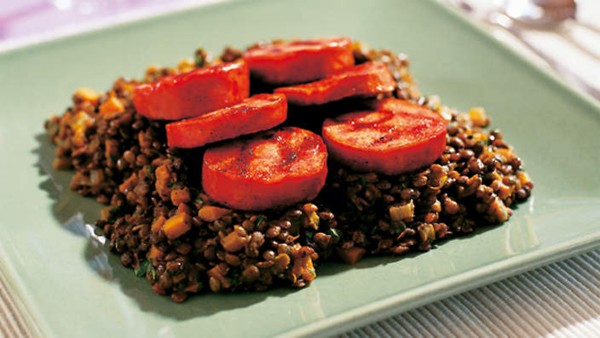 Barbecued pork sausage with spiced lentils