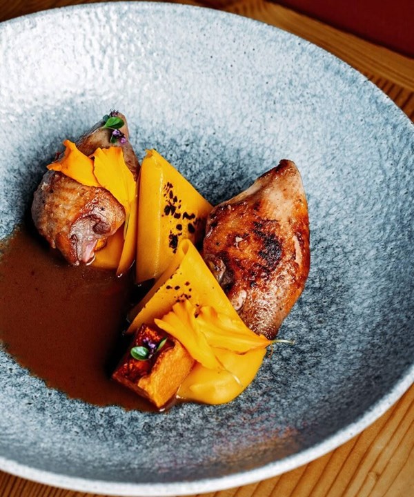 Barbecued quail with pumpkin ravioli & elderberry sauce
