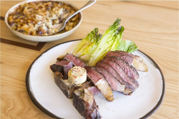 Barbecued T-bone steak with devilled butter & oxtail macaroni cheese [Adam Byatt]