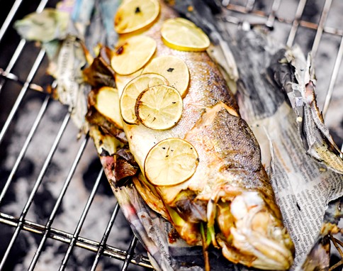Barbecued trout in newspaper
