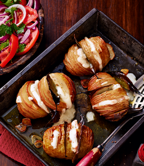 Bay and garlic-studded Hasselbacks with Taleggio