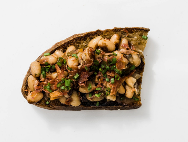 Beans on toast with crisped cured ham and chives