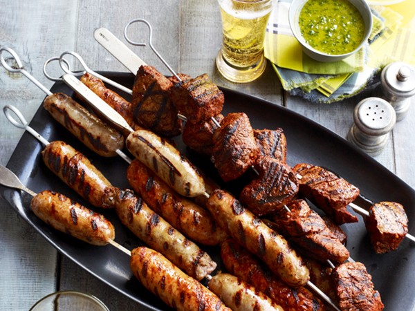 Beef and sausage kebabs with salsa and chimichurri