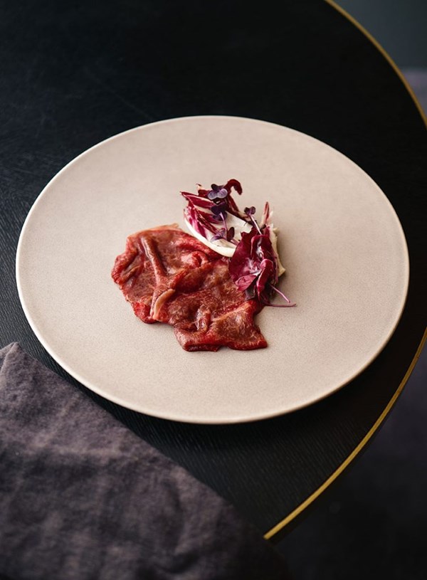 Beef carpaccio with redcurrant, radish, treviso & anchovy cream