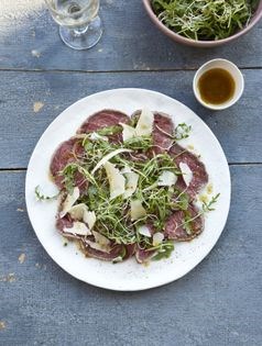 Beef carpaccio with rocket and alfalfa salad