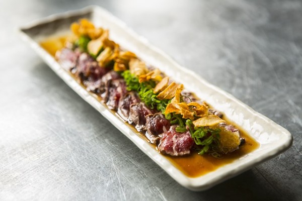 Beef fillet tataki with onion ponzu and garlic crisps