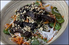 Beef satay on rice noodles