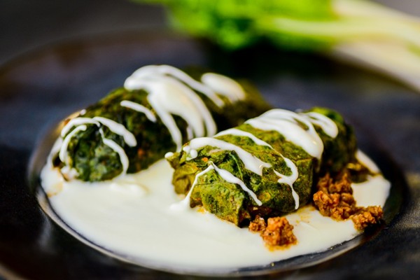 Beef-stuffed Swiss chard rolls with yogurt sauce