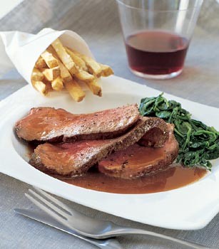 Beef tenderloin with red wine sauce, creamed spinach, and truffled French fries