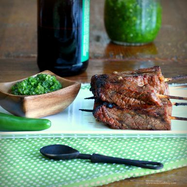 Beer and sriracha marinated beef skewers with green chile sauce