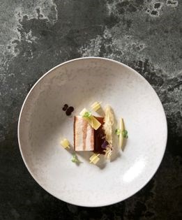 Beer-braised pork belly with sauerkraut, apple-ginger salad, and ginger jus