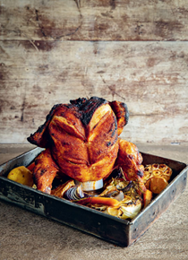 Beer can chicken with tray-baked garlic and lemon vegetables