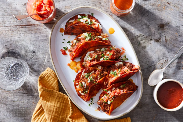 Birria de res tacos with queso Oaxaca from Salvador Alamilla [salsa cruda, salsa picosa]