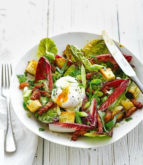 Bistro salad with poached egg, croutons, lardons and walnuts 