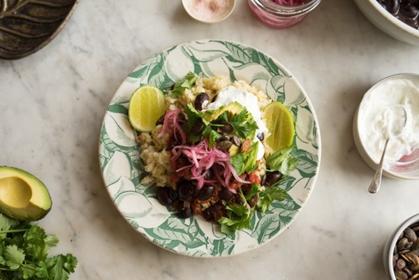 Black bean skillet dinner with quick-pickled red onion and lime crema