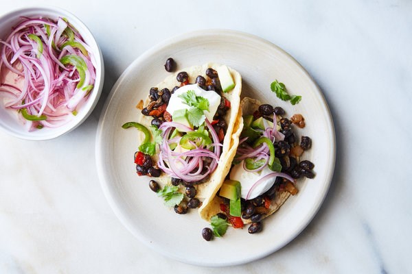 Black bean tacos with avocado and spicy onions