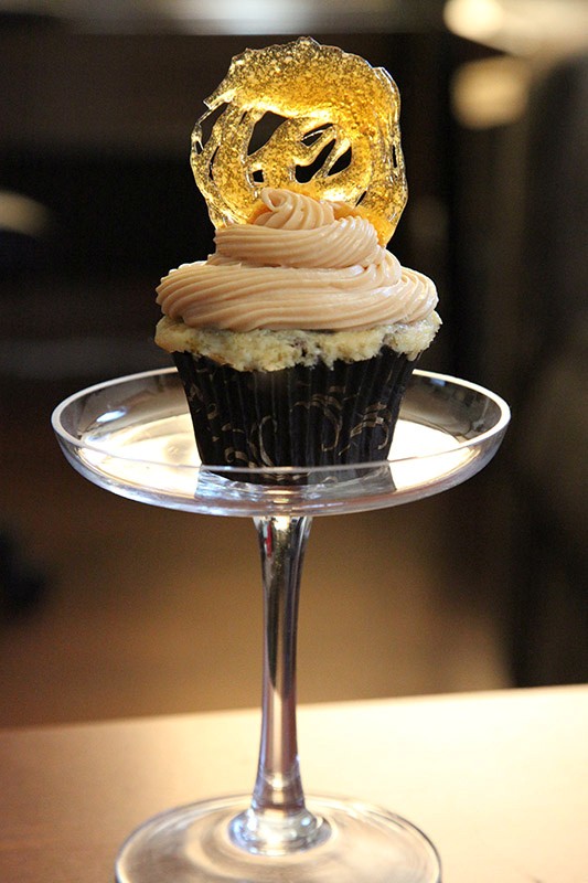 Black bottom cupcakes with salted caramel cream cheese frosting and a caramel decoration