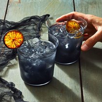 Black margaritas with torched limes 