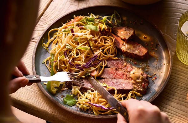 Black pepper & soy flat iron steak with noodle slaw and miso-peanut dressing