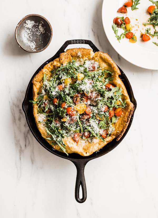 Black pepper-Parmigiano Dutch baby with arugula and cherry tomatoes