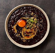 Black rice congee with tahini sauce and cured yolk