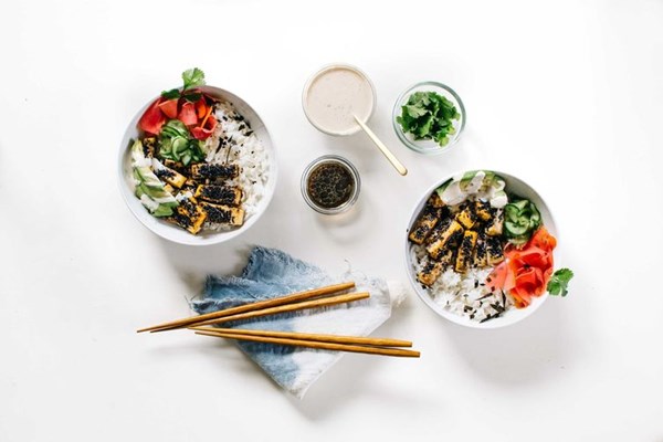 Black sesame-crusted tofu bowl with quick-pickled veggies & cilantro tahini