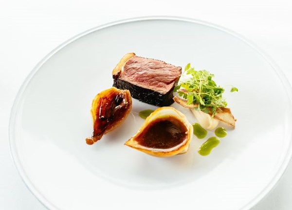 Blackened sirloin steak with salted caramel onions and parsley salad