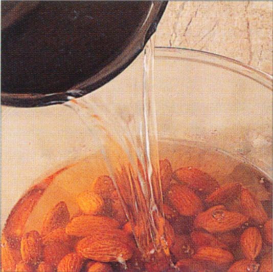 Blanching and skinning almonds