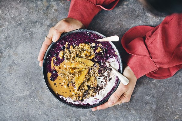 Blueberry chia bowl with warm banana and sesame brittle