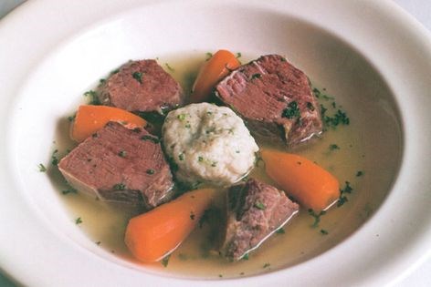 Boiled salt beef with carrots and dumplings