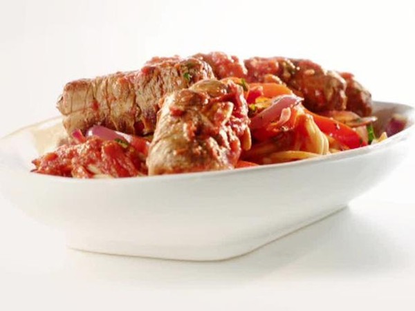 Braciole & sausages in Sunday gravy with peppers & onions