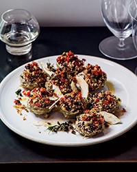 Braised artichoke hearts stuffed with olives and herbs