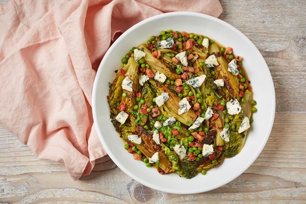 Braised baby gem and peas topped with Saint Agur