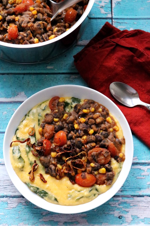 Braised black bean stew with cheesy spinach polenta and fried shallots